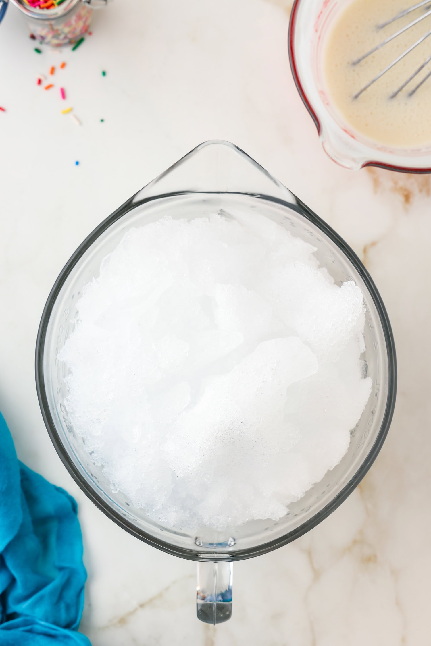 Snow in a large glass measuring bowl.