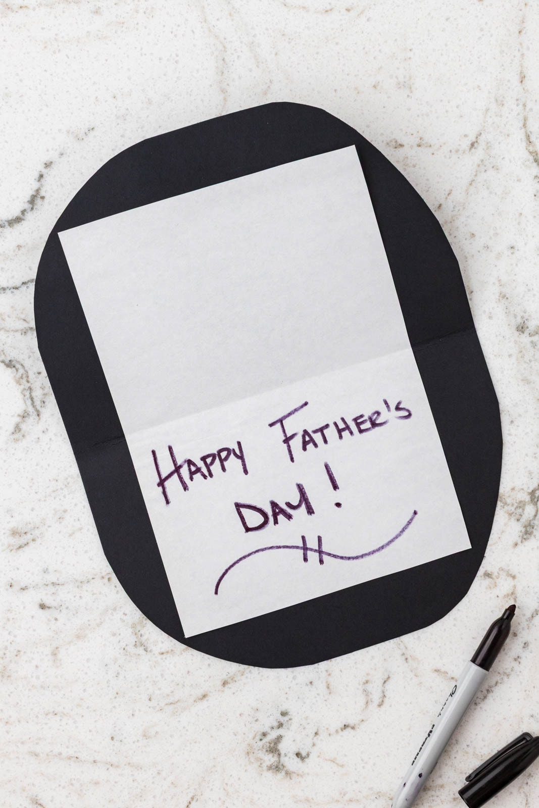 Handwritten “Happy Father’s Day!” message on white paper attached inside a black grill-shaped card.