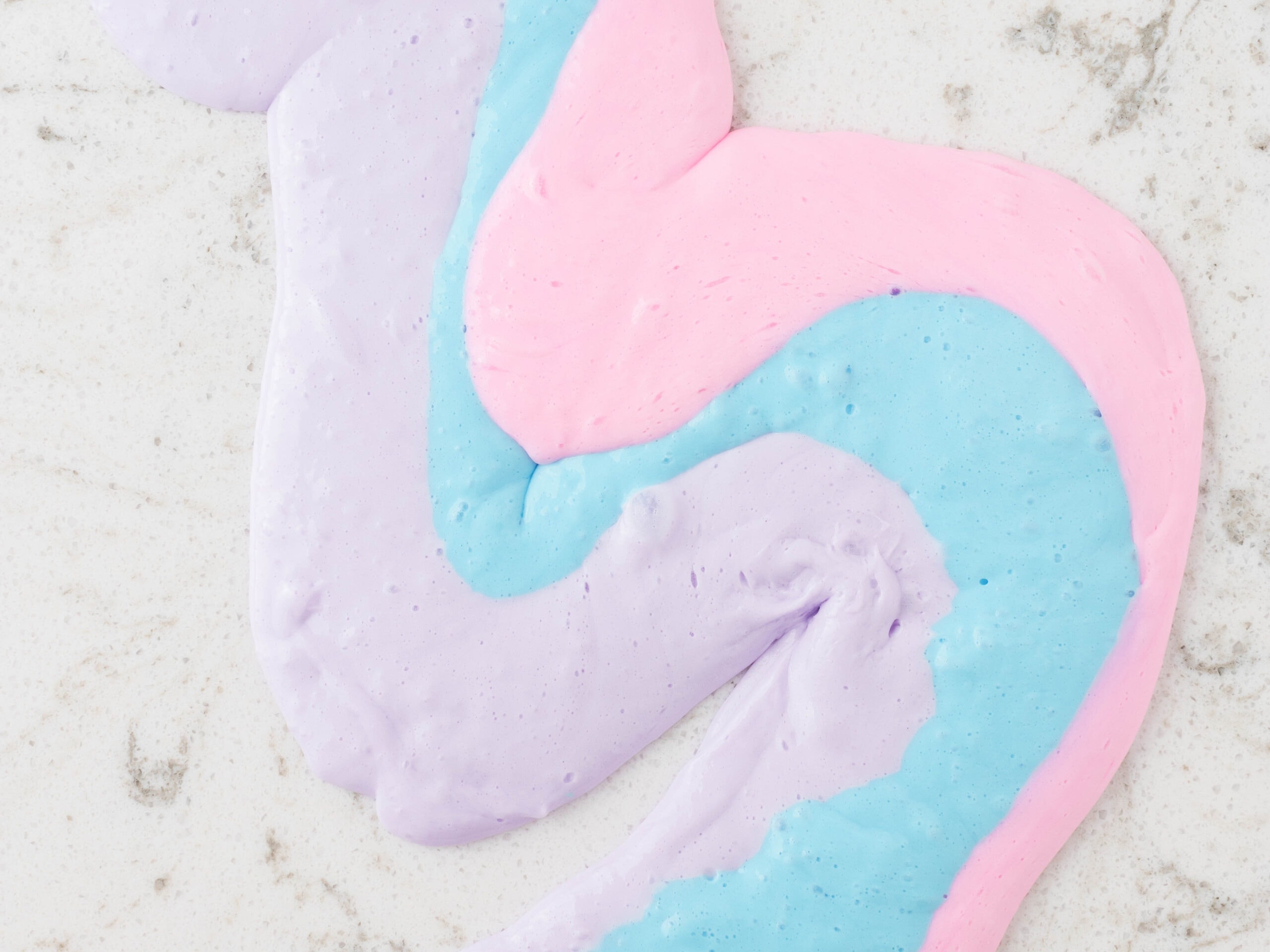 Lay Slime on the table in Strips to combine and mix Colors together.