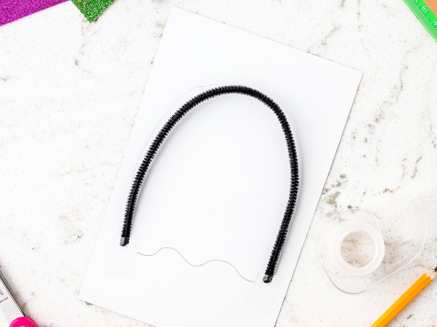 Black pipe cleaner bent in a U