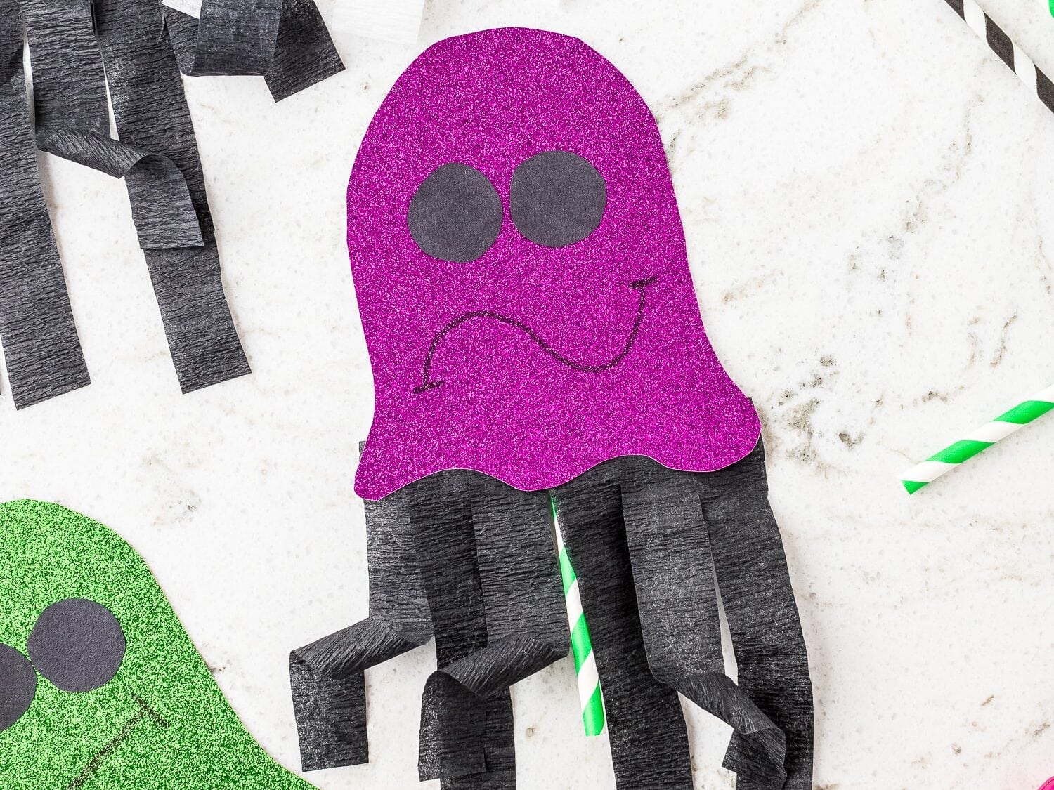 Purple glittery ghost craft on marble background