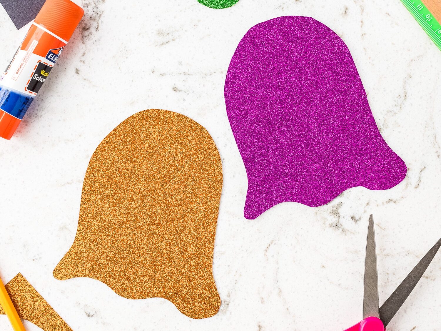 Ghost shape cut out of green, orange and purple glitter cardstock
