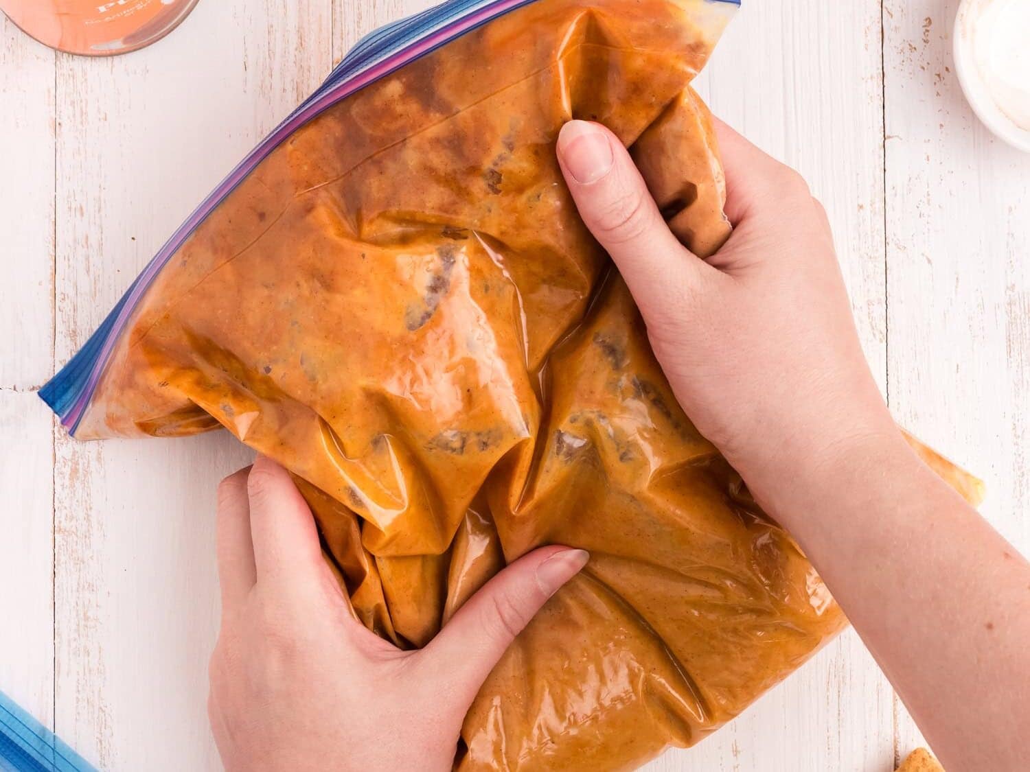 Kneading the spices into the The gallon zip lock opened to add the spices for the Pumpkin Pie in a Bag with the zip locks secured