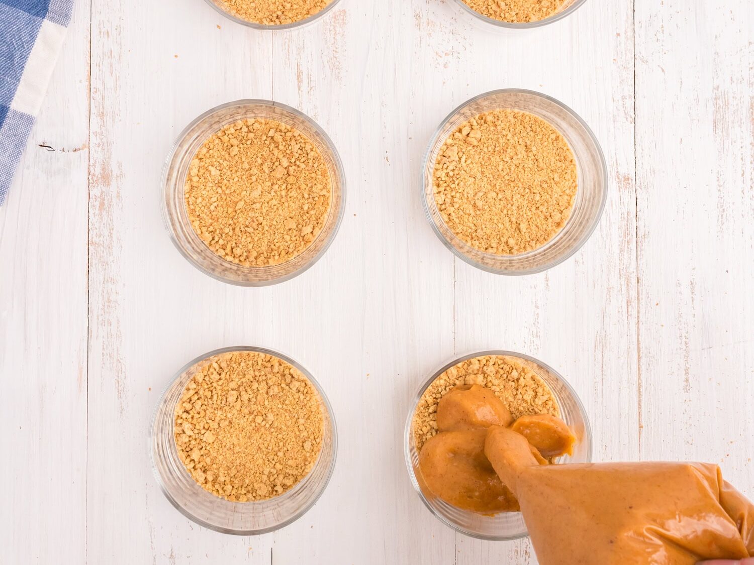 Crushed graham crackers in bottom of serving cups and piping in pumpkin mixture with slit cut in gallon bag for Pumpkin Pie in a Bag recipe