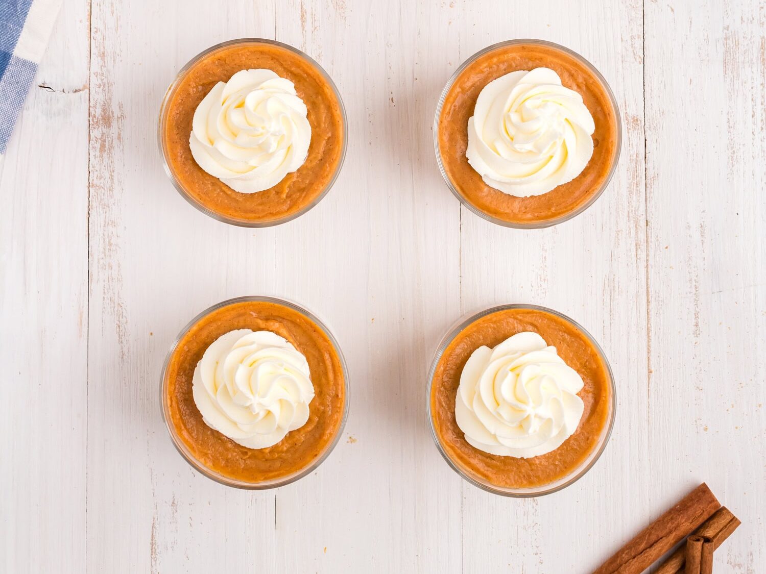 Adding dollop of whipped topping to Pumpkin Pie in a Bag in small serving cups